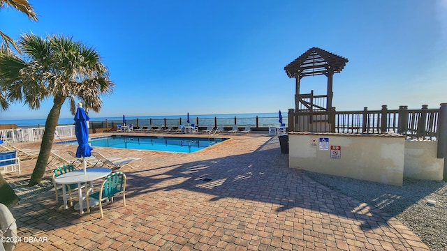 1233 N Atlantic Ave Unit 212, Daytona Beach, FL 32118 - community pool featuring fence, a patio, and a water view
