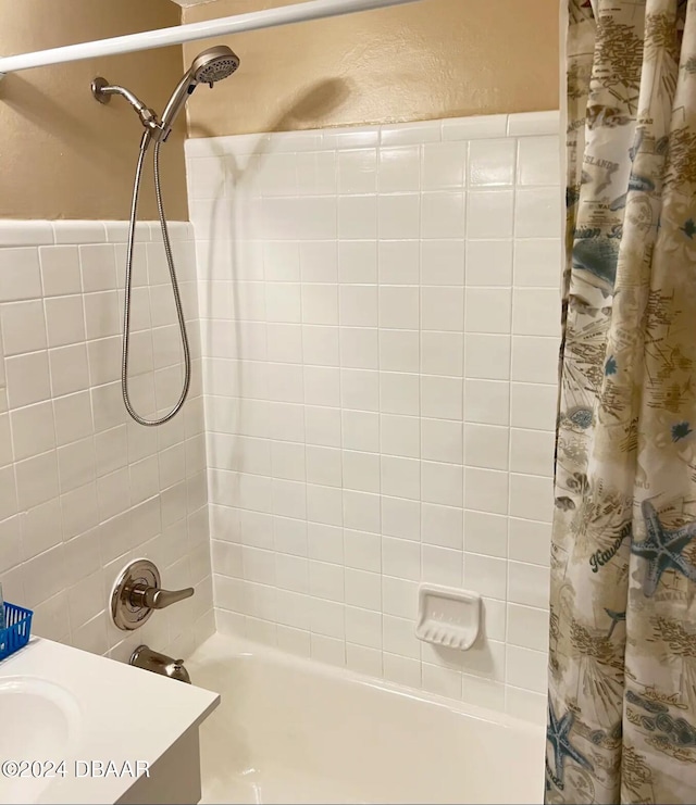 bathroom with shower / bath combo with shower curtain