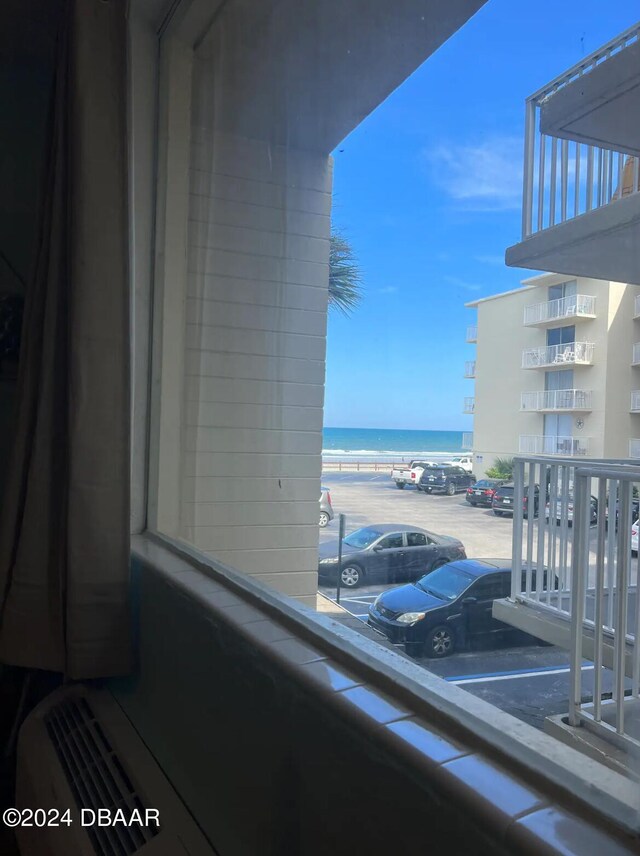 balcony featuring a beach view and a water view