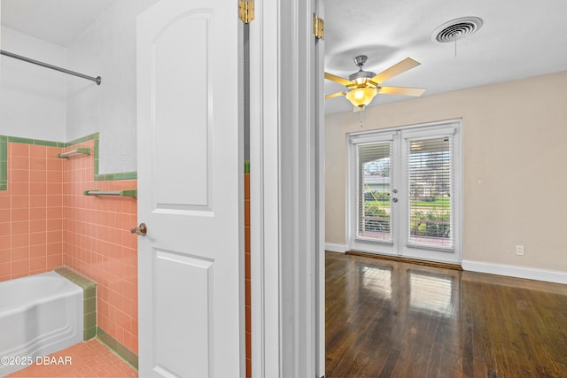 bathroom featuring french doors, visible vents, ceiling fan, wood finished floors, and baseboards