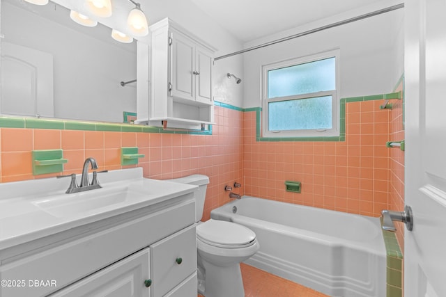 full bathroom featuring toilet,  shower combination, vanity, and tile walls