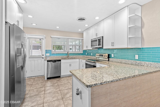 201 Woodland Ave, Daytona Beach, FL 32118 - kitchen featuring stainless steel appliances, a sink, open shelves, white cabinetry, and recessed lighting
