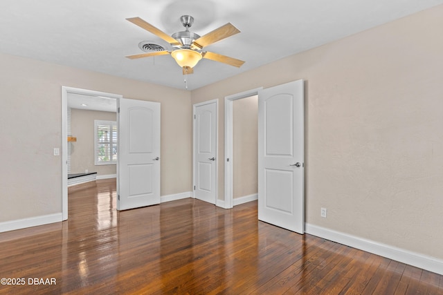 unfurnished bedroom featuring a ceiling fan, baseboards, and hardwood / wood-style floors