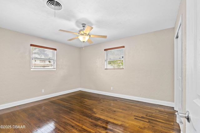 unfurnished room with wood-type flooring, visible vents, ceiling fan, and baseboards