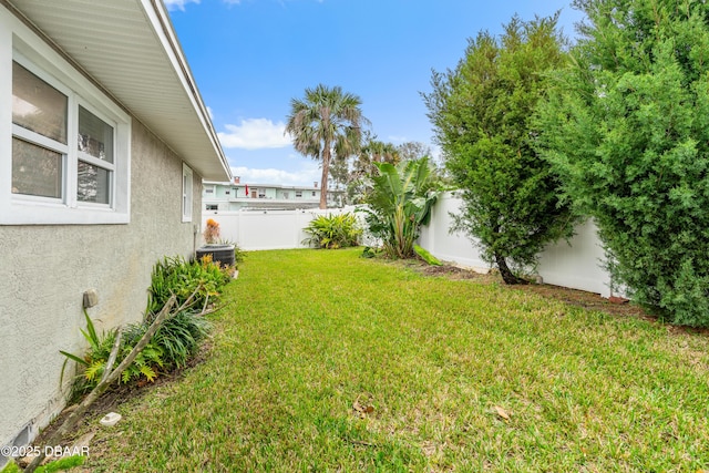 view of yard featuring a fenced backyard and central AC