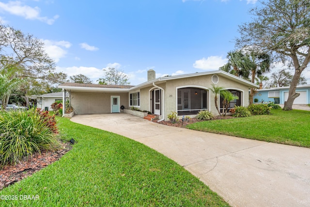 ranch-style house featuring driveway, a chimney, a front lawn, and stucco siding