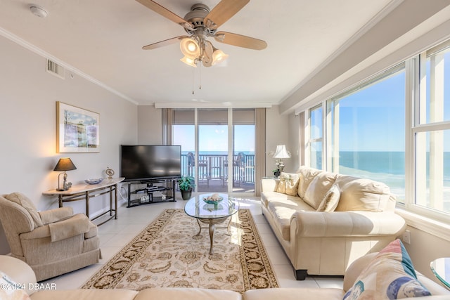 living room with floor to ceiling windows, crown molding, ceiling fan, and light tile patterned floors