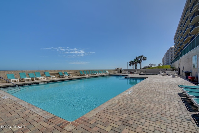 view of swimming pool with a patio area