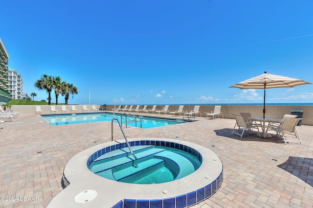 view of swimming pool with a community hot tub and a patio area