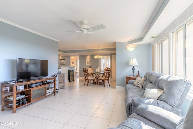 tiled living room with ceiling fan with notable chandelier and crown molding