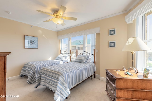 bedroom with multiple windows, ceiling fan, light colored carpet, and ornamental molding