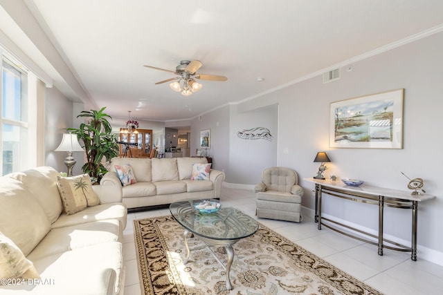 tiled living room with ceiling fan and ornamental molding