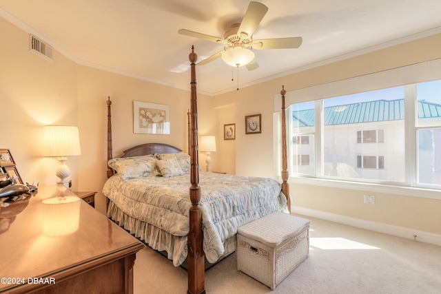 bedroom featuring ceiling fan, light colored carpet, and ornamental molding