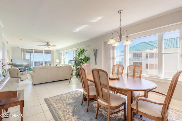 dining room featuring light tile patterned floors, ceiling fan with notable chandelier, and ornamental molding