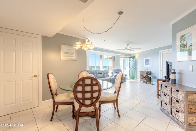 tiled dining room featuring ceiling fan with notable chandelier and crown molding