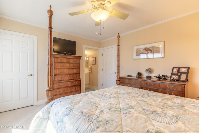 carpeted bedroom with ensuite bathroom, ceiling fan, and ornamental molding