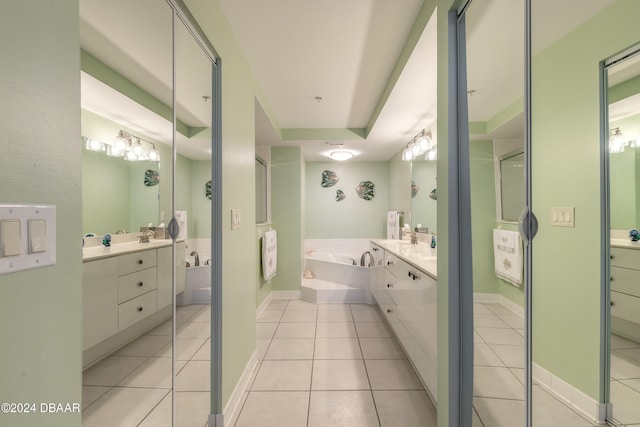 bathroom featuring a raised ceiling, vanity, shower with separate bathtub, and tile patterned floors