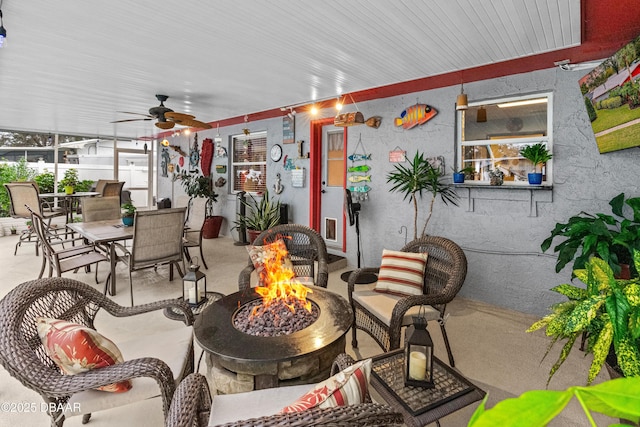 view of patio featuring ceiling fan and an outdoor fire pit