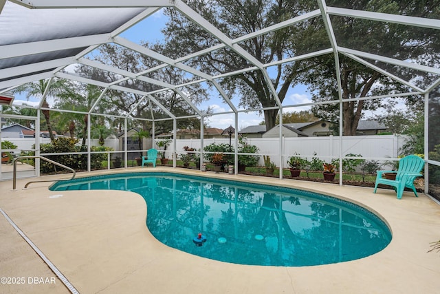 view of swimming pool featuring a patio area, a lanai, and a shed