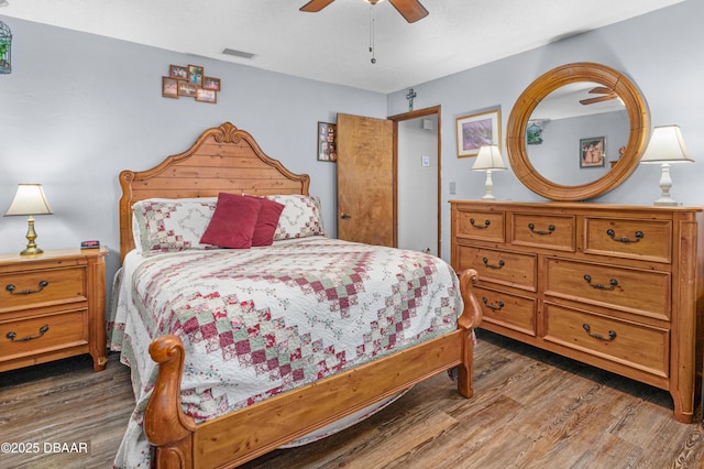 bedroom with dark wood-type flooring and ceiling fan