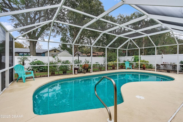 view of swimming pool with a patio and glass enclosure