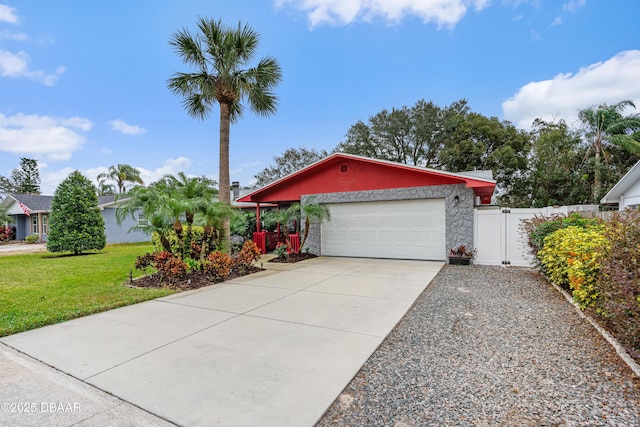 view of front of home featuring a front yard and a garage