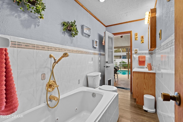 bathroom featuring hardwood / wood-style floors, tile walls, a tub to relax in, toilet, and ornamental molding