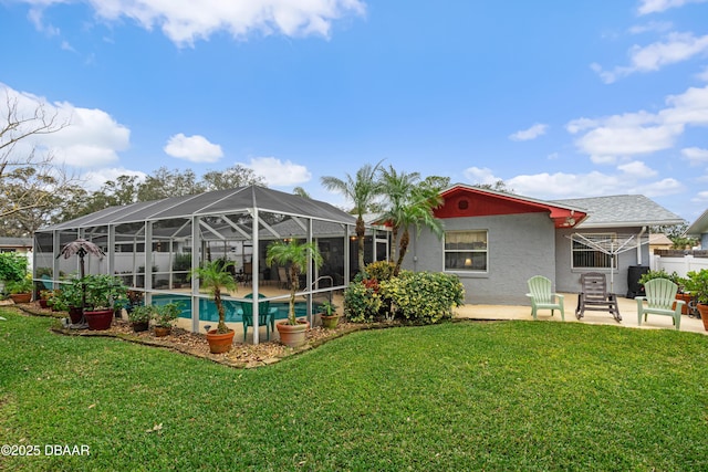 rear view of house featuring a lanai, a yard, and a patio