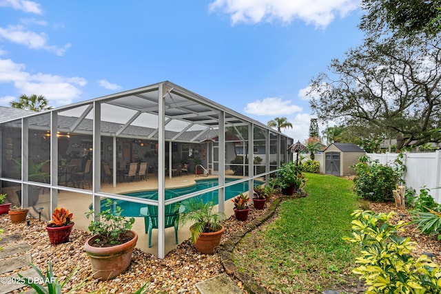 view of swimming pool with a shed and a patio area