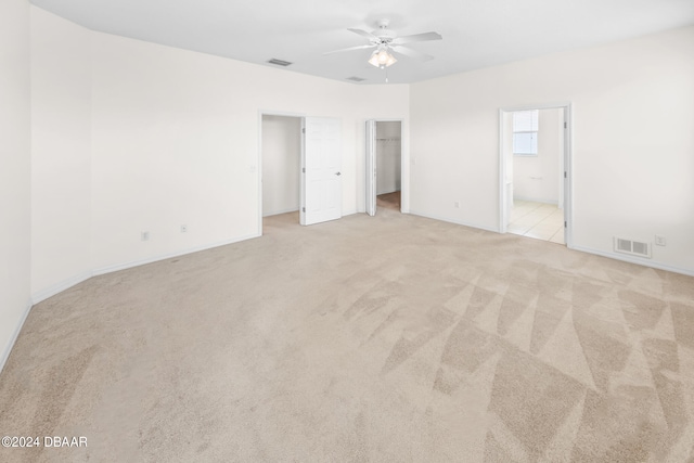 spare room featuring ceiling fan and light colored carpet