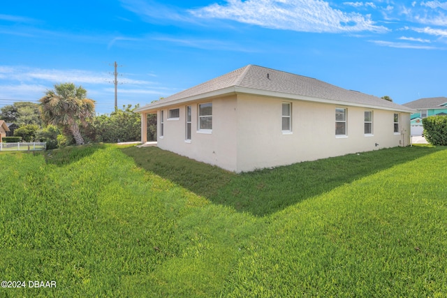 view of property exterior with a yard