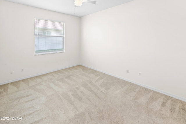 unfurnished room featuring ceiling fan and light carpet