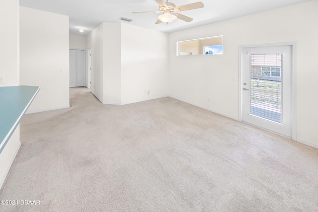 carpeted spare room featuring ceiling fan