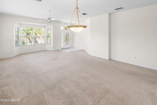 unfurnished living room with light carpet and ceiling fan