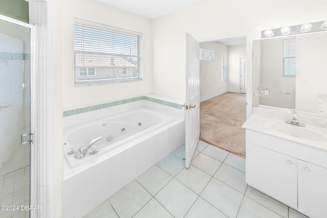 bathroom with shower with separate bathtub, vanity, and tile patterned floors