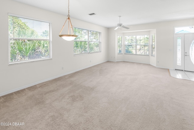 interior space featuring ceiling fan and a wealth of natural light