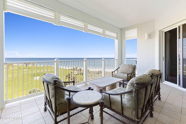 view of patio / terrace featuring a beach view and a water view