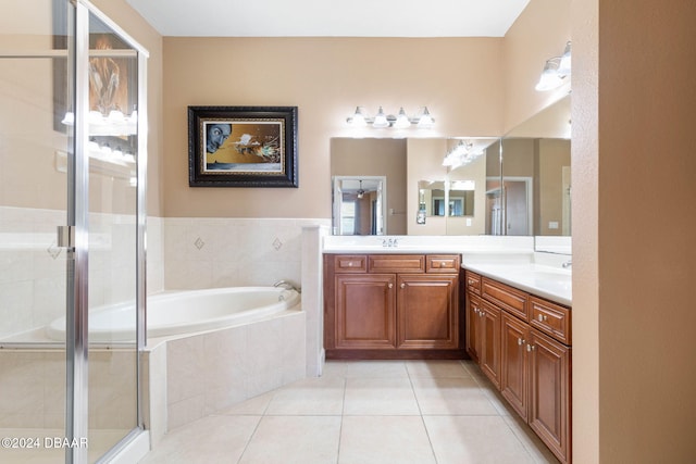 bathroom featuring independent shower and bath, vanity, and tile patterned flooring