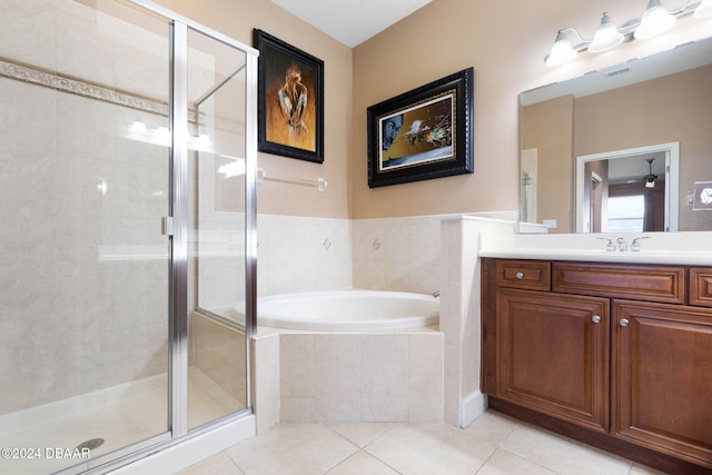 bathroom featuring vanity, tile patterned floors, and shower with separate bathtub