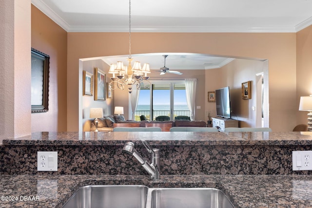 kitchen with decorative light fixtures, sink, ornamental molding, and ceiling fan with notable chandelier