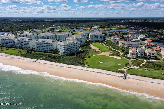 drone / aerial view featuring a water view and a view of the beach