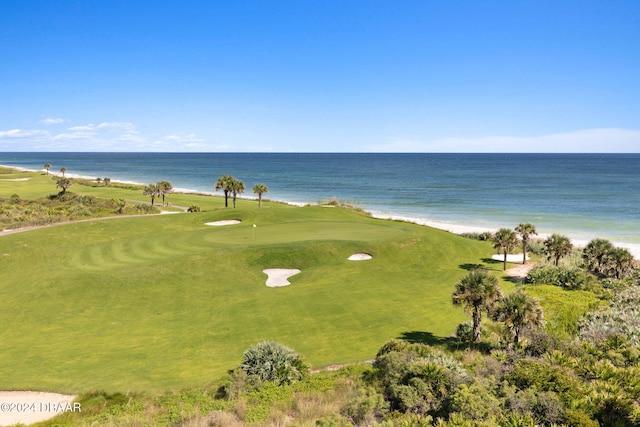 view of property's community featuring a water view and a lawn