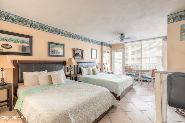 tiled bedroom featuring ceiling fan