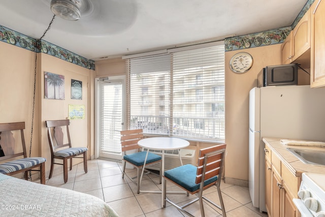 dining room featuring ceiling fan and light tile patterned flooring