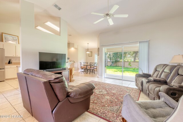 living room with ceiling fan, light tile patterned floors, and high vaulted ceiling