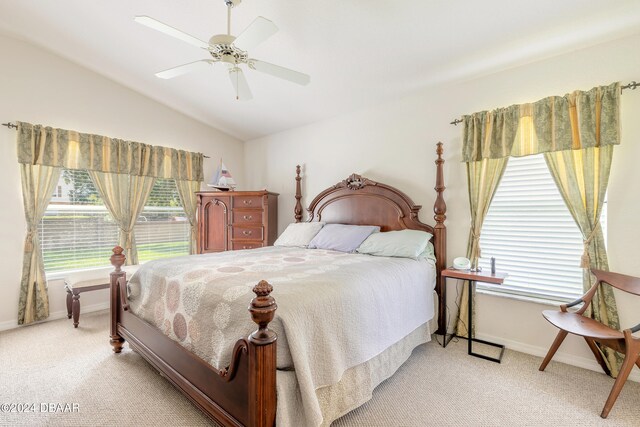 bedroom with light colored carpet, ceiling fan, and vaulted ceiling