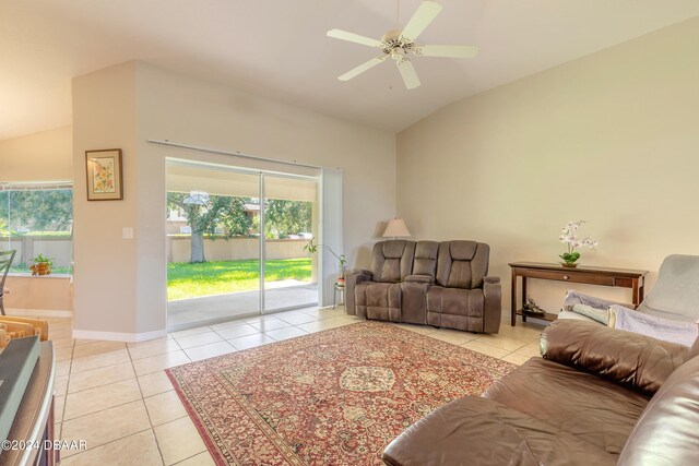 tiled living room featuring lofted ceiling and ceiling fan