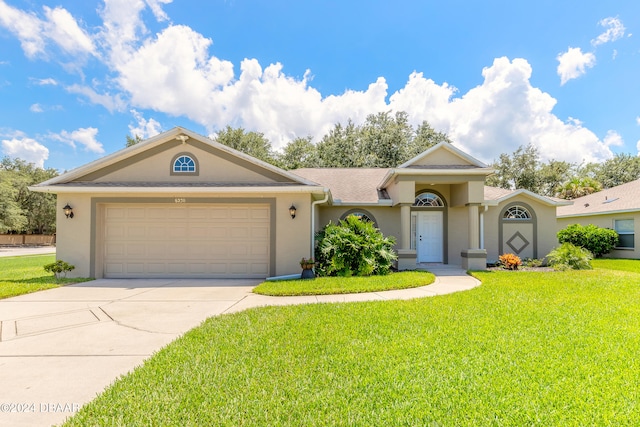 ranch-style house featuring a front lawn and a garage