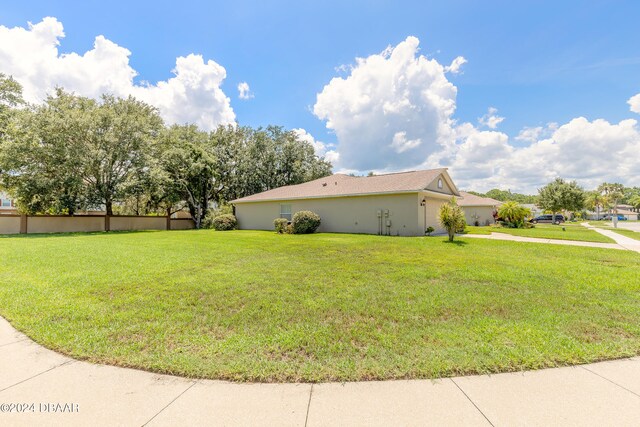 view of side of property with a lawn