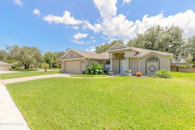 ranch-style house with a garage and a front yard